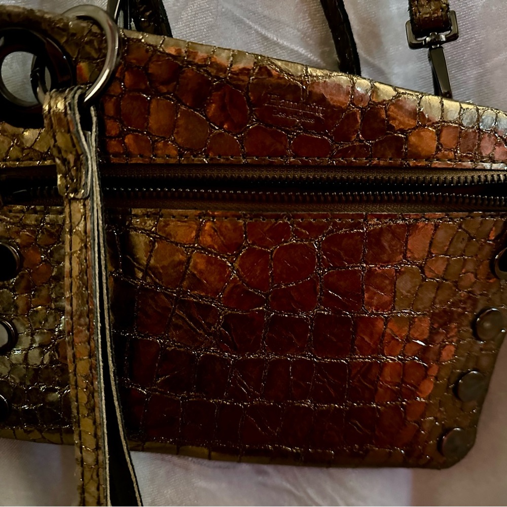 Hammitt Gold embossed leather with red accents, excellent condition